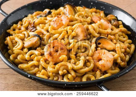 Traditional Spanish Fideua. Noodle Paella On Wooden Table