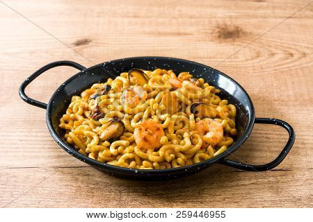 Traditional Spanish Fideua. Noodle Paella On Wooden Table