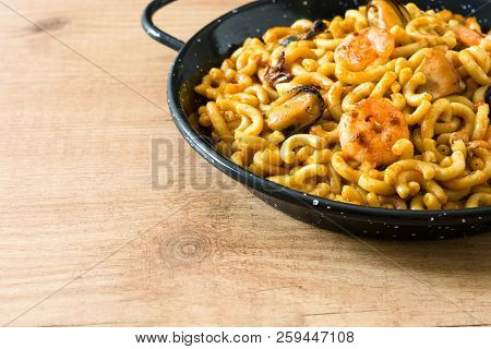Traditional Spanish Fideua. Noodle Paella On Wooden Table. Copyspace
