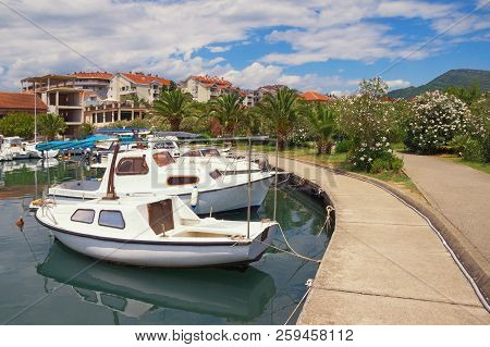 Picturesque Mediterranean Landscape. Embankment Of Seaside Town, With View Of  Fishing Boats In Harb