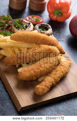 Deep fried chicken frites with potato chips or french fries