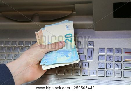 Many Euro Banknotes At Atm And The Hand