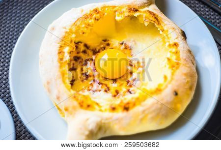 Ajarian Or Adjaruli Khachapuri, Filled With Cheese And Topped With A Raw Egg And Butter - Traditiona