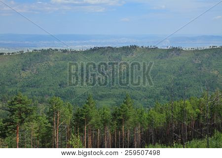Mountains Covered With Forest. In The Background, The City Of Chita. Siberia, Transbaikalia