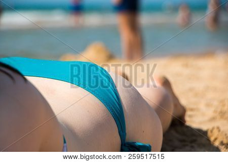 Girl Sunbathing On A Summer Beach. Remembering The Summer