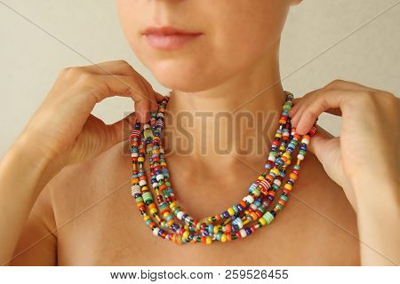 Bright Beads Of Murano Glass On A Young Girl. A Girl Dresses And Button Beads, Jewelry