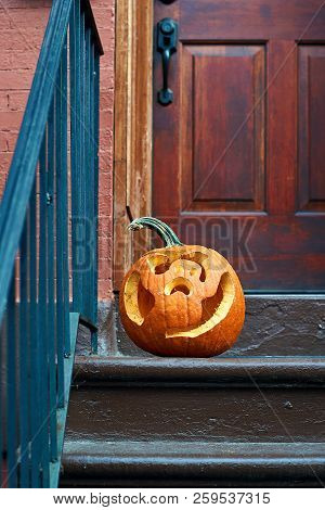 Carved Halloween Pumpkins Or Jack O'lantern On The Doorstep In Brooklyn