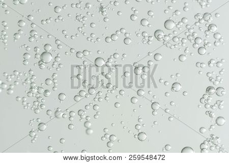 Many Small Liqiud Bubbles Isolated Over A Blurred Background.