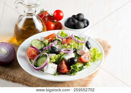Fresh Greek Salad Made Of Cherry Tomato, Ruccola, Arugula, Feta, Olives, Cucumbers, Onion And Spices