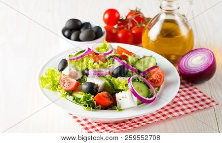 Fresh Greek Salad Made Of Cherry Tomato, Ruccola, Arugula, Feta, Olives, Cucumbers, Onion And Spices