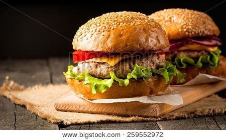 Close-up Photo Of Home Made Hamburger With Beer Made Of Beef, Onion, Tomato, Lettuce, Cheese And Spi