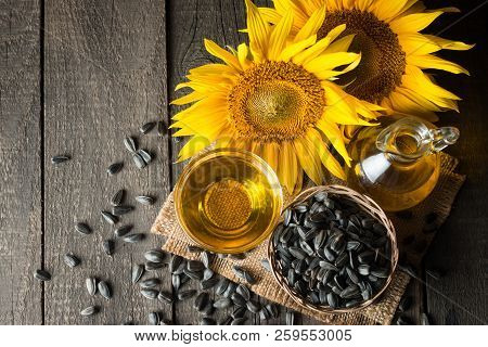 Sunflower Oil And Sunflower Seeds In Small Sack On Traditional Rustic Wooden Background. Organic And