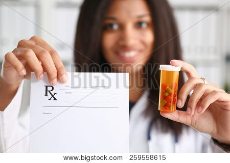 Female Black Doctor Hands Hold And Give To Visitor Prescription And Jar Of Pills Closeup. Panacea Li