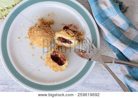 Top View Of A Colorful Plate With Plum Dumplings On Wooden Table/ Closeup Still Life Food Photograph