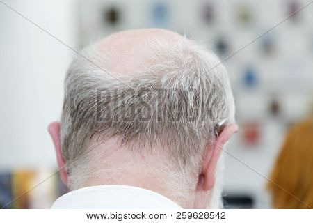 Head Of An Old Man With A Deaf Aid.