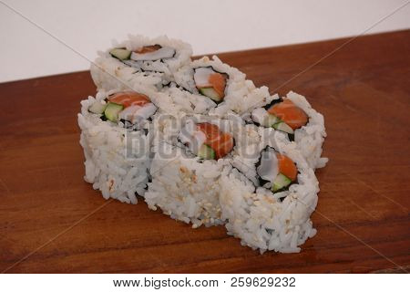 Sushi California Philly Rolls Appetizer With Rice Avocado And Salmon On Square Blue Plate W/ Chopsti