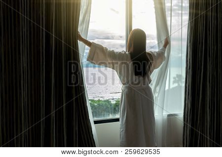 Back Side Of Asian Woman In Bathrope Suit When Waking Up From The Bed In Luxury Hotel In Morning, Li