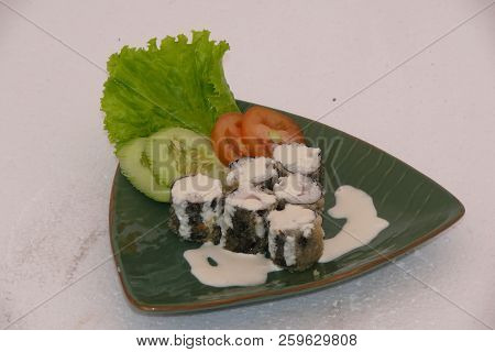Sushi California Philly Rolls Appetizer With Rice Avocado And Salmon On Square Blue Plate W/ Chopsti