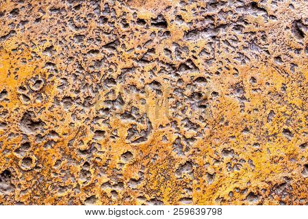 Many Rugged Holes On The Rusty Color Concrete Floor
