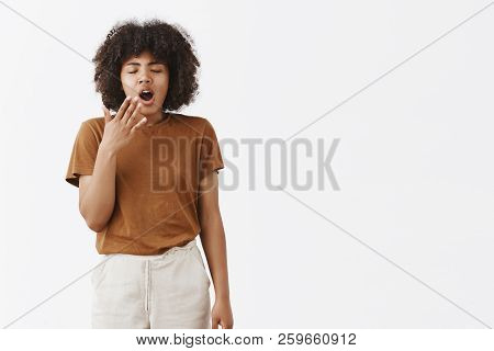 Hate Jetlag. Portrait Of Sleepy Cute African American Woman With Afro Hairstyle Closing Eyes And Yaw