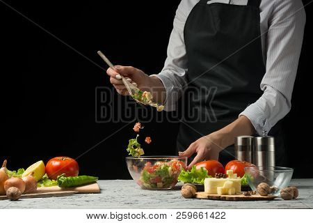 Freezer Food Prepare In Process Vegetarian Salad By Chef Hand In Home Kitchen. Dark Black Background