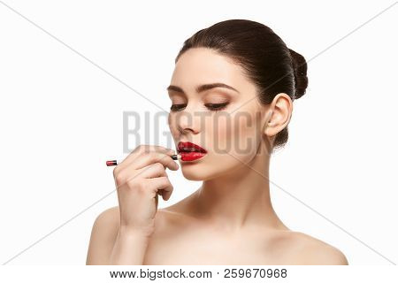 Girl Applying Red Lipstick Isolated On White