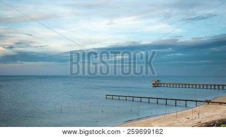 Beach, Bridge And The Moon Is Rising At 
Nim Seng Beach, Songkhla, Thailand.