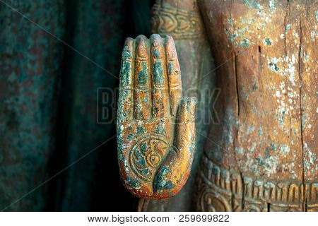 Wheel Of Dhamma On Palm Of Old Buddha Statue