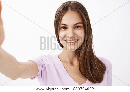 Close-up Shot Of Charming Young Happy European Female Brunette With Long Strong Hair And Clean Sking