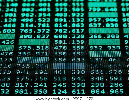 Concept Of Financial Data On A Monitor. Display Of Stock Market Quotes On Dark Background. Photo Of 
