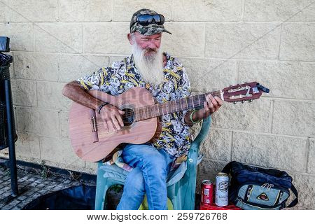 Torrevieja, Spain - Sept. 23 2018 :  Merlin Busking With Guitar Outside Carrefour Store