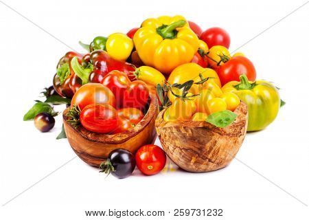 Assorted tomatoes and vegetables isolated on white background. Photo for your design.