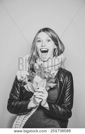 Woman With Autumn Leaves In Leather Jacket. Happy Model With Stylish Hair In Scarf. Beauty And Fashi