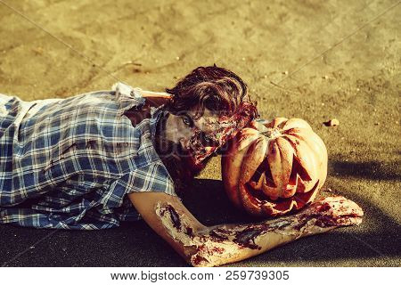 Bearded Zombie Man With Beard Creepy Vampire Or Bloody War Soldier With Wounds And Red Blood Lies On