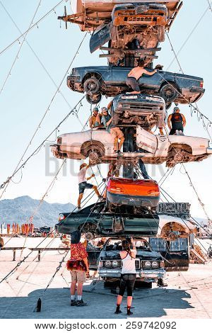 Guatemala - July 30, 2018. People Climbing Up The Huge Art Car Installation In The Middle Of A Deser