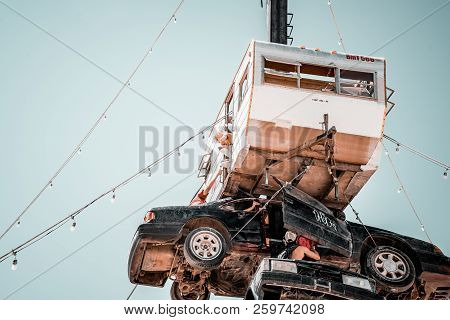 Guatemala - July 30, 2018. People Climbing Up The Huge Art Car Installation In The Middle Of A Deser