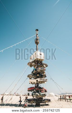 Guatemala - July 30, 2018. People Climbing Up The Huge Art Car Installation In The Middle Of A Deser