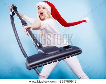 Woman Vacuuming The House, Last Minute. Teen Girl In Santa Helper Hat With Vacuum Cleaner, Angry Fur