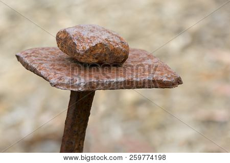 Old Rusting Metal Stake Found At An Old Mine Site. Very Shallow Depth Of Field Used On Just The Cent