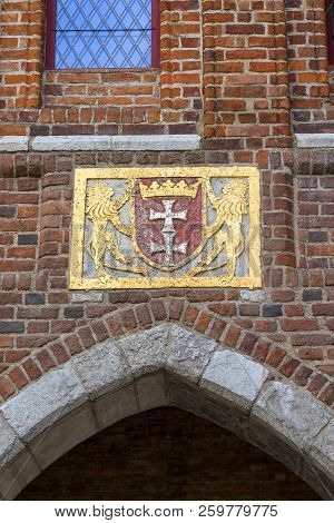 15th Century Mariacka Gate By The River Motlawa, Arms On The Facade, Long Bridge, Gdansk, Poland.