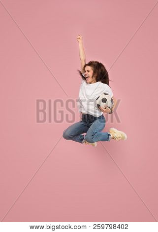 Forward To The Victory.the Young Woman As Soccer Football Player Jumping And Holding The Ball At Stu