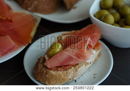 Typical Spanish Tapa (cured Ham Snack) Or Montadito With Jamon Iberico. Slice Of Rustic Bread With E