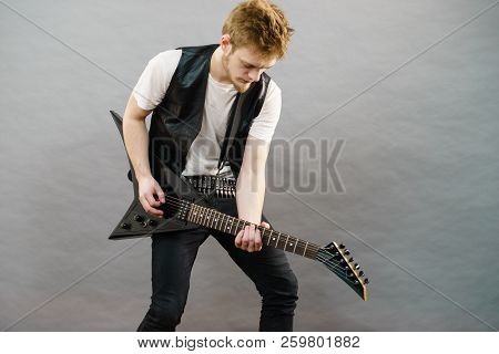 Teen Hardcore Man Wearing Metal Outfit Playing On Electric Guitar Heavy Rock Music.