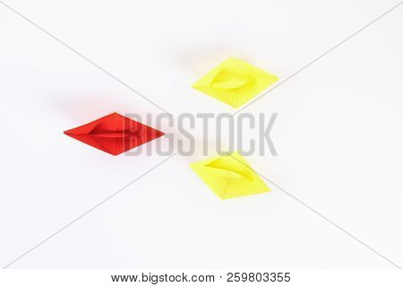 Red Paper Boat Among Other White. Leadership, White Crow, Individuality. Piranhas And A Shark. Not L