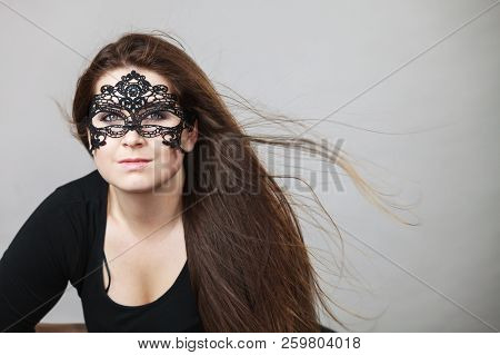 Pretty Mysterious Woman Wearing Black Eye Lace Mask Having Tousled Windblown Long Brown Hair.