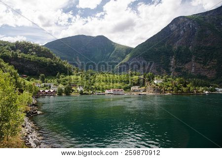 Houses In Flam Village Near Beautiful Mountains On Coast Of Majestic Aurlandsfjord Aurlandsfjorden ,