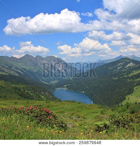 Green Meadows, Lake Arnensee And Summer Clouds