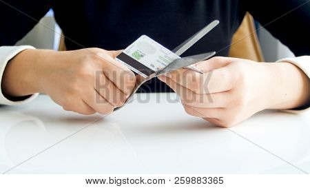 Closeup Image Of Young Woman Cutting Credit Card With Scissors