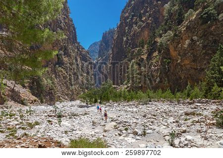 The Famous Samaria Gorge In The White Mountains On The Island Of Crete In Greece. Tourists Walking A
