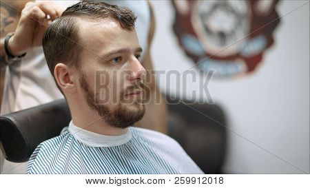Men's Haircut In Barbershop. Master Barber Does A Haircut To The Client. Work With Scissors And Clip